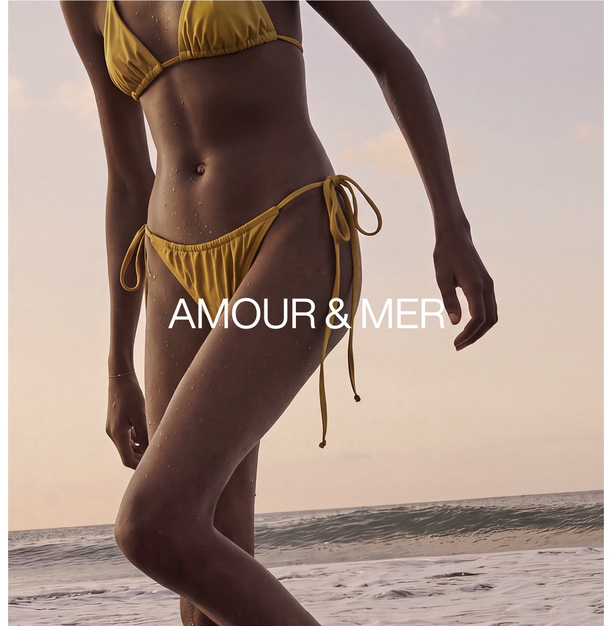Model wearing Amour & Mer swimwear on the beach